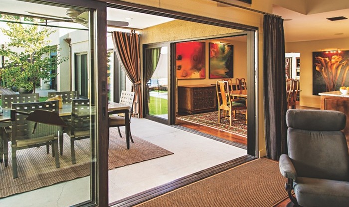 A living room featuring Milgard sliding glass doors, connecting to a dining area in San Jose, CA.