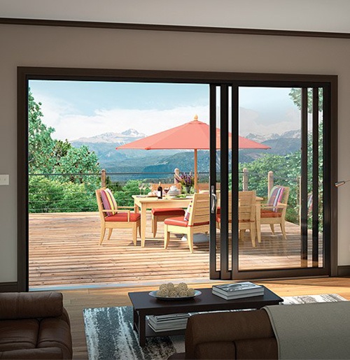 Living room with stacking glass doors opening to a patio in San Jose, CA.